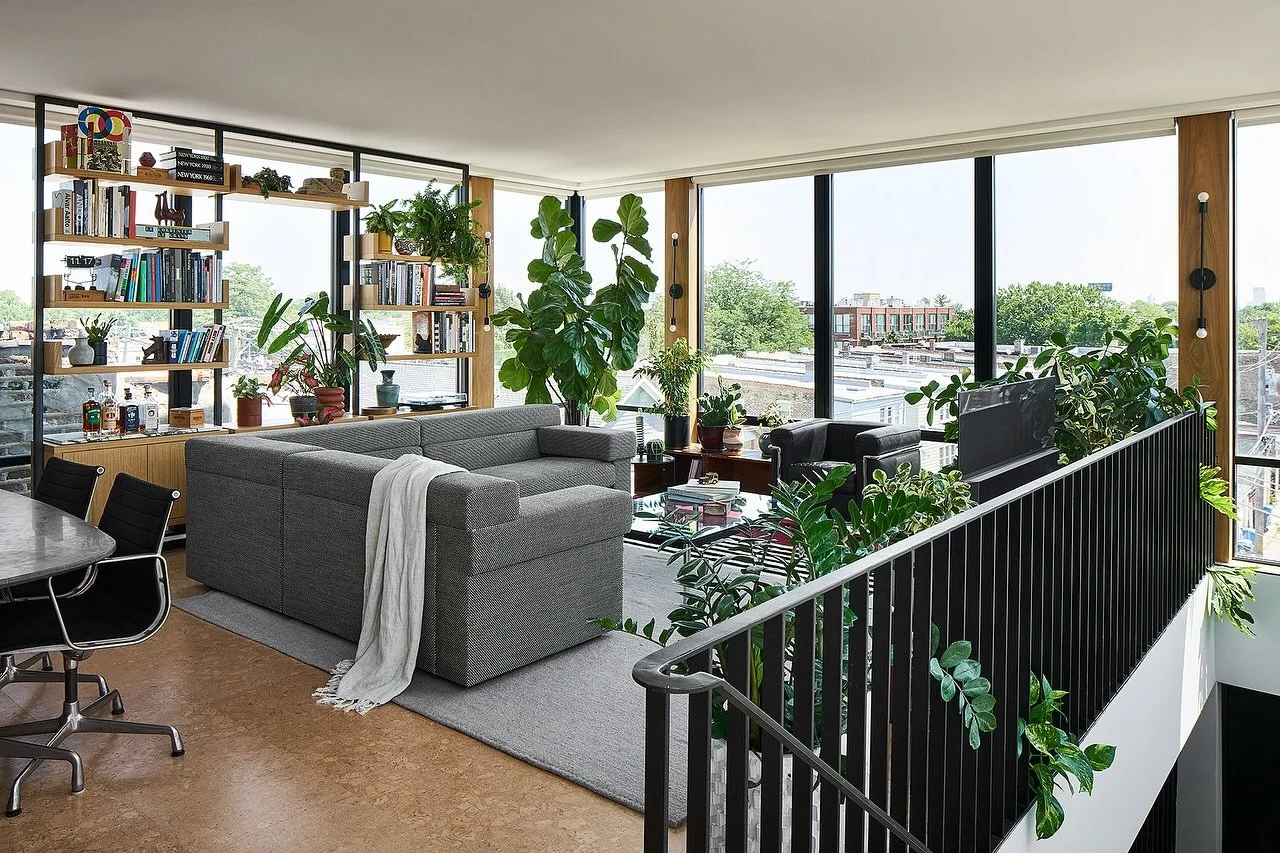 Rooftop / Located a story above neighboring rooftops this modern home boasts continuous windows on all sides. These expanses of glass are punctuated by walnut clad posts and a custom oak and steel shelving unit. It&rsquo;s the perfect spot to take in
