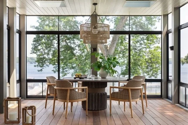 Screened Porch / This oversized screened porch is peak lake living at our Powers Lake, Wisconsin Project. Convertible screens, an outdoor fireplace, and heaters extend its use into chilly fall nights while skylights keep the space light and bright ye
