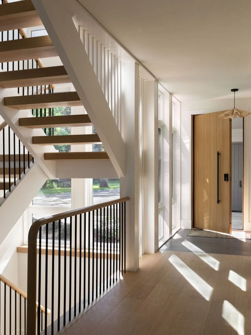 Stair + Entry / A casual entry brings you by a mudroom along a wall of windows and this contemporary staircase. The stair switches back in front of more windows and its open risers and slatted sides let long evening shadows stretch through the house.