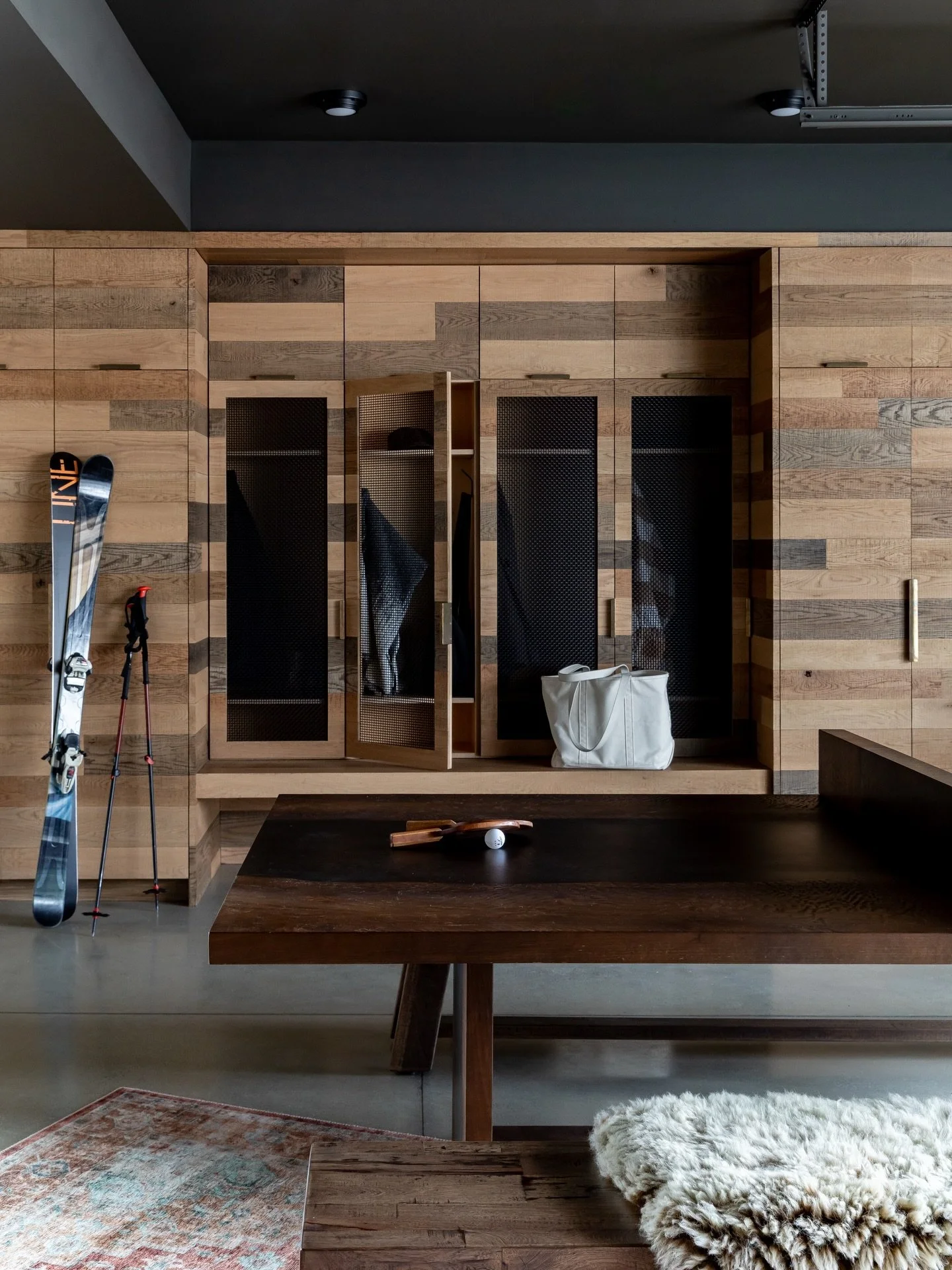 Party Garage / This apartment City guest house has the coolest barn in town. A frosted glass garage door lets light in while heated floors keep the space cozy. The client uses the multipurpose space as ski storage, a mudroom, game room, and a lab for