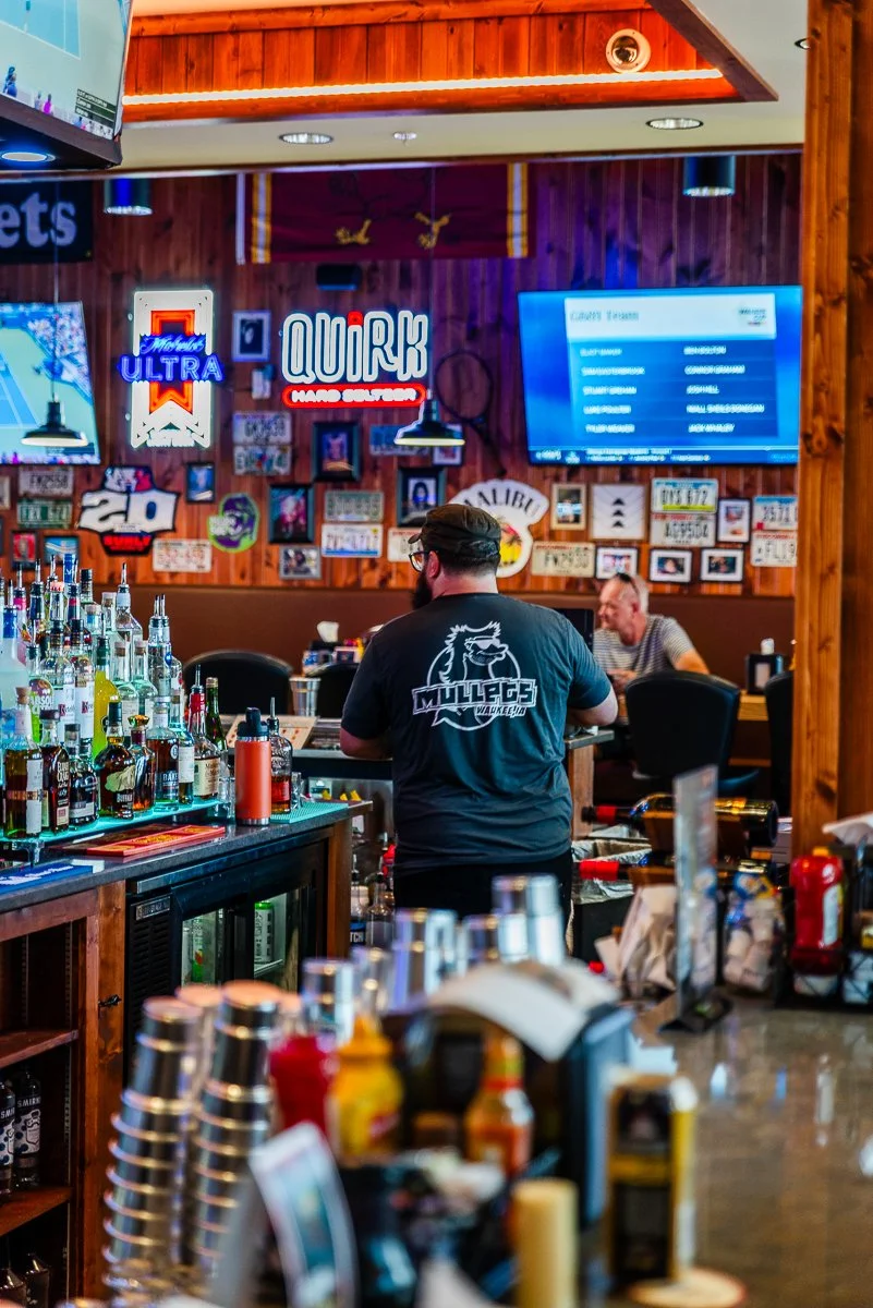 Mullets Waukee Employee behind bar at grand opening
