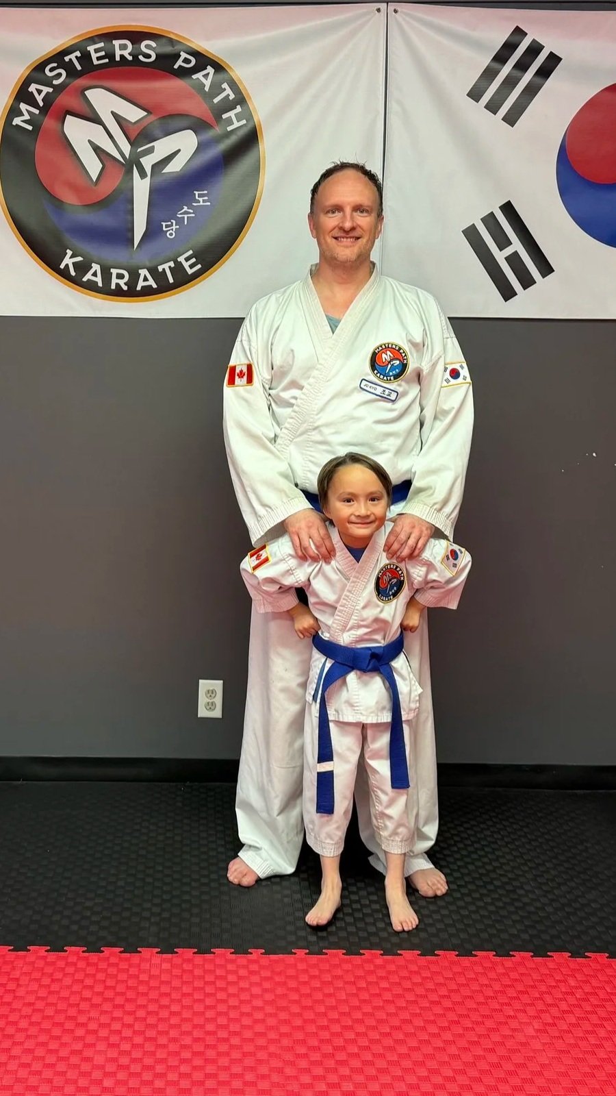 Masters Path Karate Students a man and his son posing for a picture