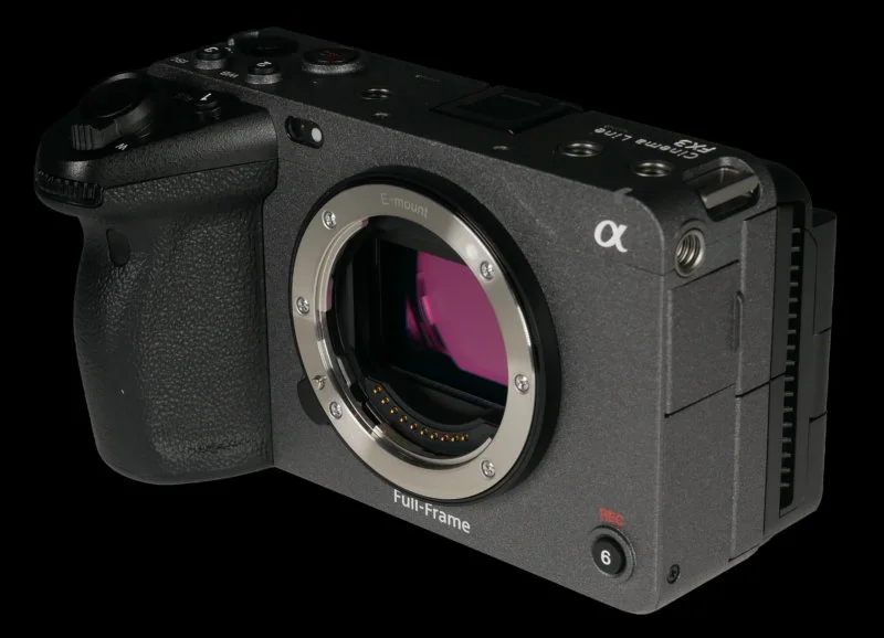 A black digital mirrorless camera with a large sensor, labeled 'Full-Frame,' featuring various controls and a textured grip, showing the camera lens mount without a lens attached.
