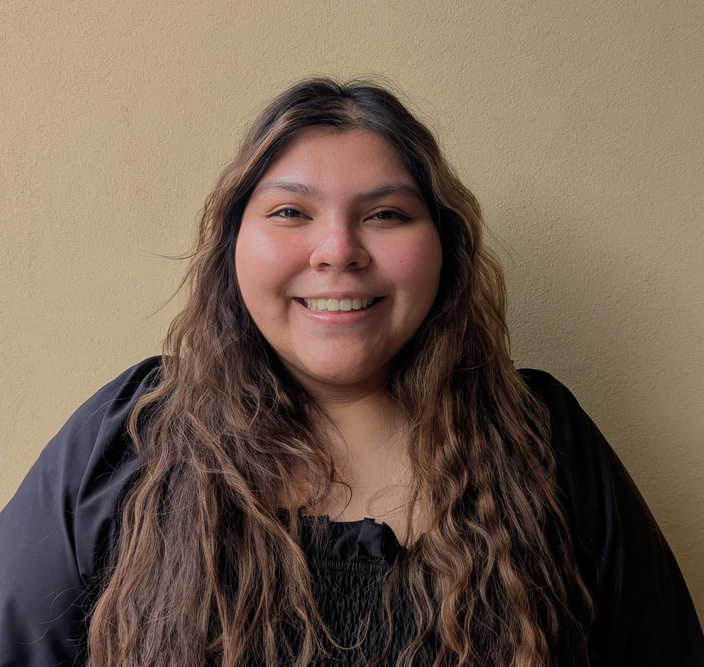 Picture of the digital navigator. He is Caucasian and has brown eyes, and red hair. He is wearing a black jacket with a blue vest underneath, and smiling at the camera.