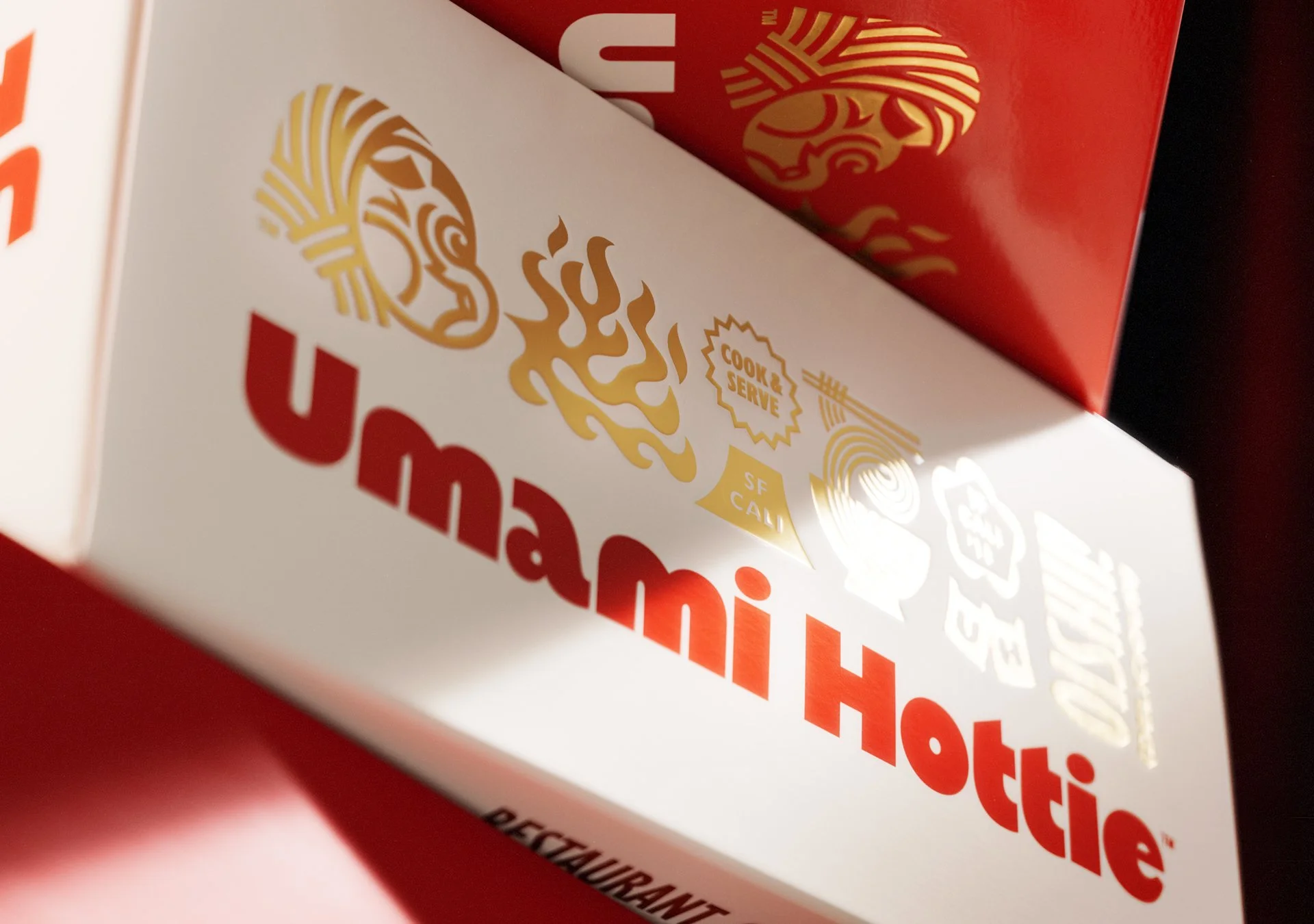 A close up view of the Umami Hottie ramen box highlighting gold foil effects on the top