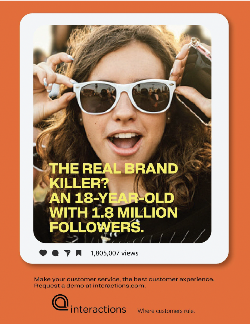 A young woman with curly hair wearing sunglasses and headphones, smiling and looking excited at a public event or outdoor gathering.