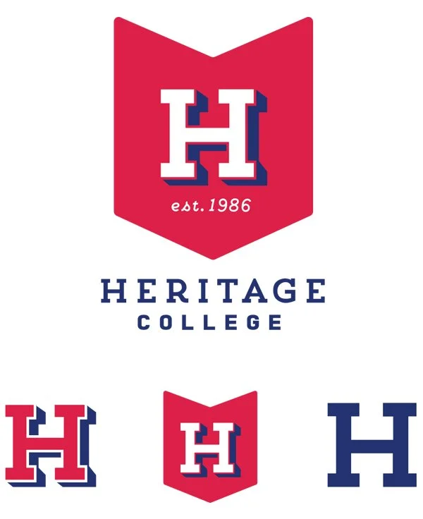 Heritage College logo with a red shield background, white letter 'H' outlined in blue, and the text 'est. 1986' below the 'H'. The words 'HERITAGE COLLEGE' are written below the shield.