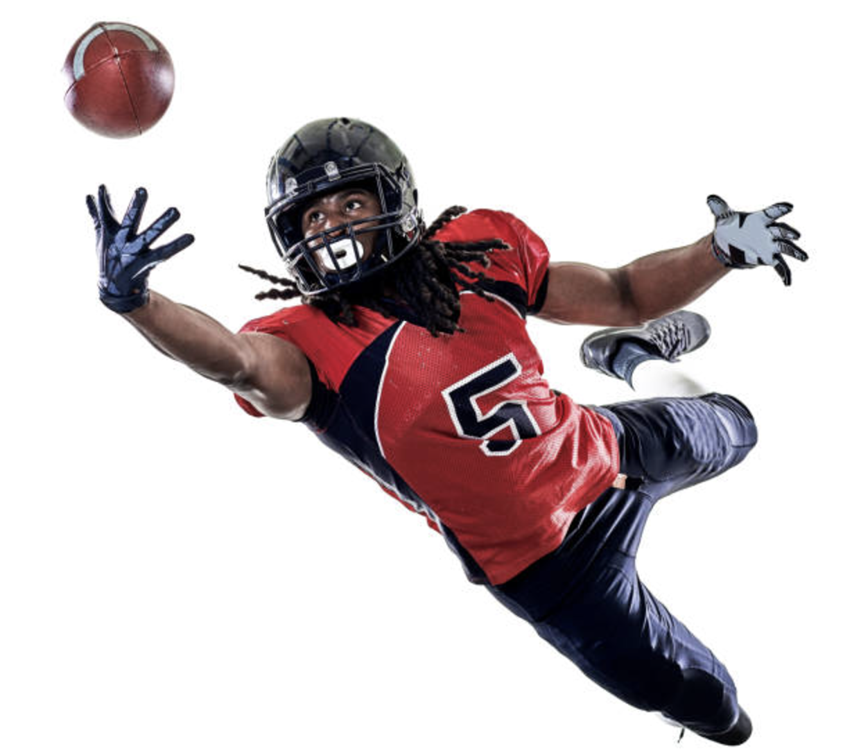 American football player in mid-air catching a football, wearing a red jersey with number 5, blue pants, and helmet.