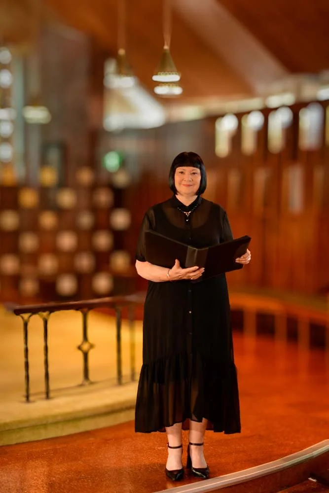 Kathleen Lloyd-Parker in church, dressed in black for a funeral service.