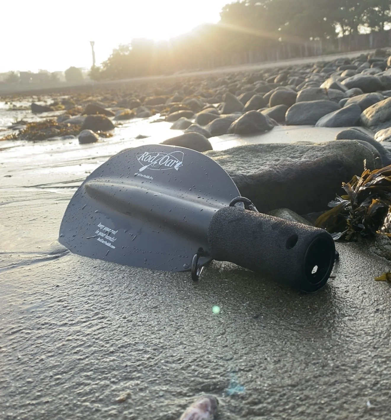 RodPaddle kayak fishing paddle attachment on beach