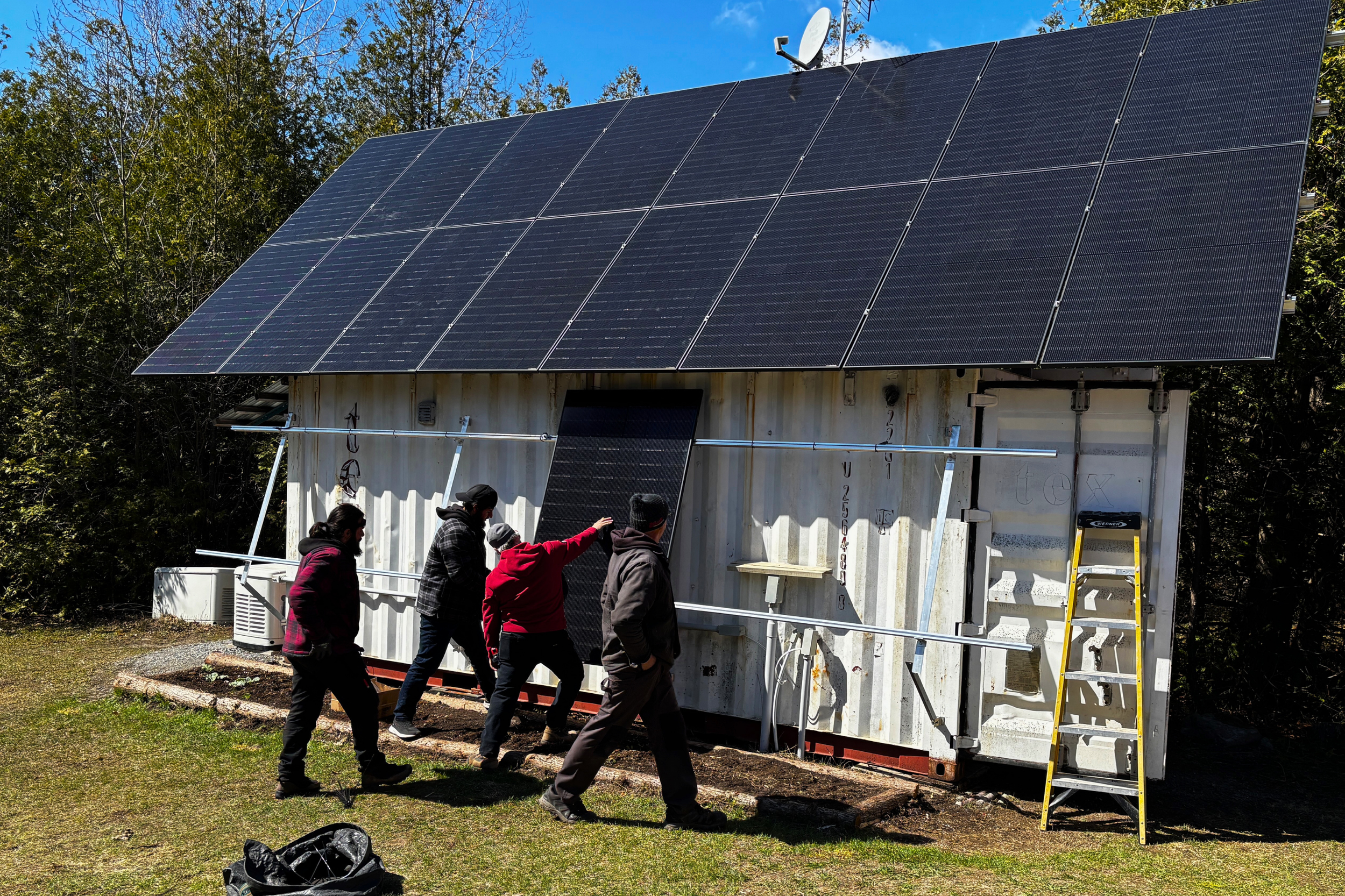 After completing the main roof section of the array, our team installed the vertical panels which will be turned on in late fall to take advantage of the lower sun and snow reflection for increased power output. 