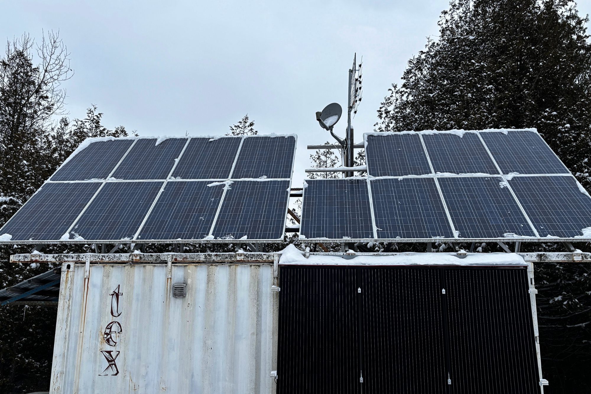 Before the upgrade, during our on-site evaluation of the off-grid system.
Solar panels covered in snow highlight real winter conditions and the seasonal performance challenges we design for in Ontario.