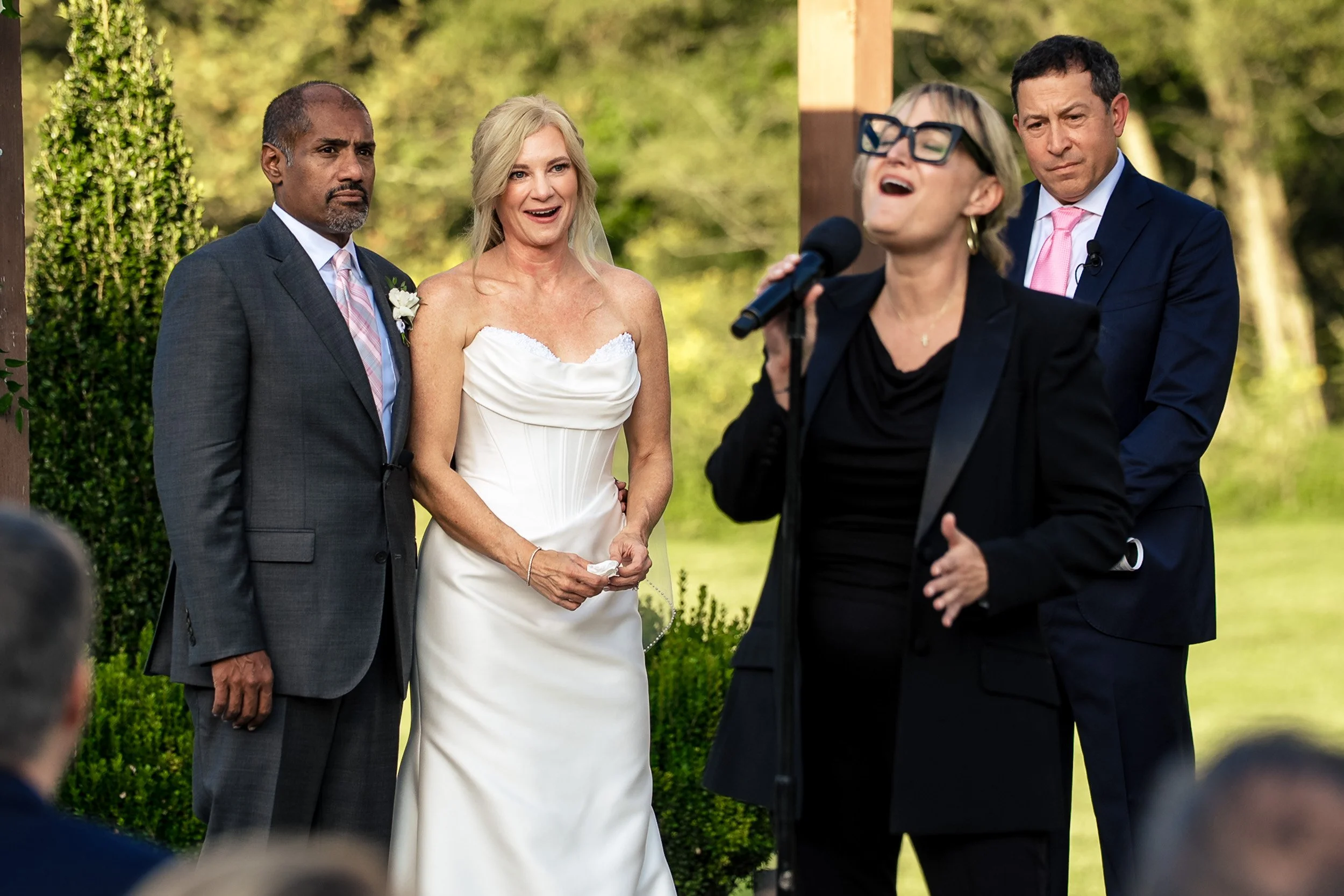 bride and groom watching friend sing