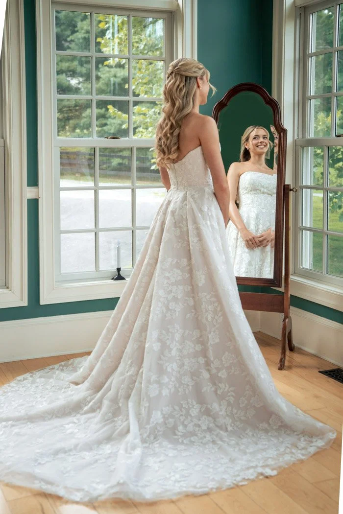 Editorial bridal portrait of Fiona admiring her wedding gown in Manassas, Virginia.`