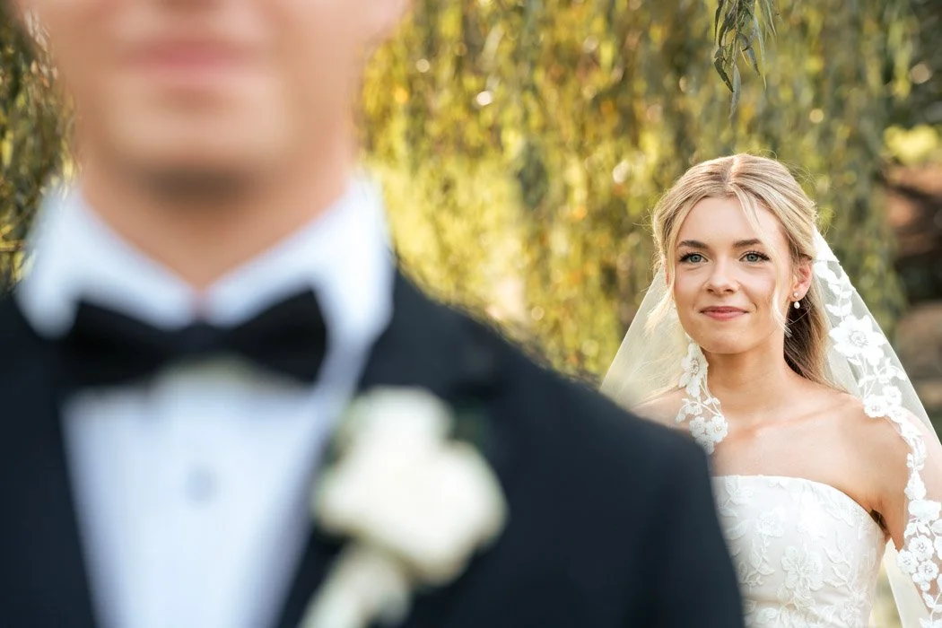 Cole waiting as Fiona approaches for their first look at their Manassas wedding.`