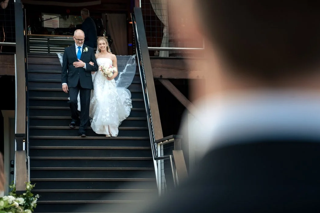 Fiona walking down the aisle with her father during her Manassas, Virginia wedding.`