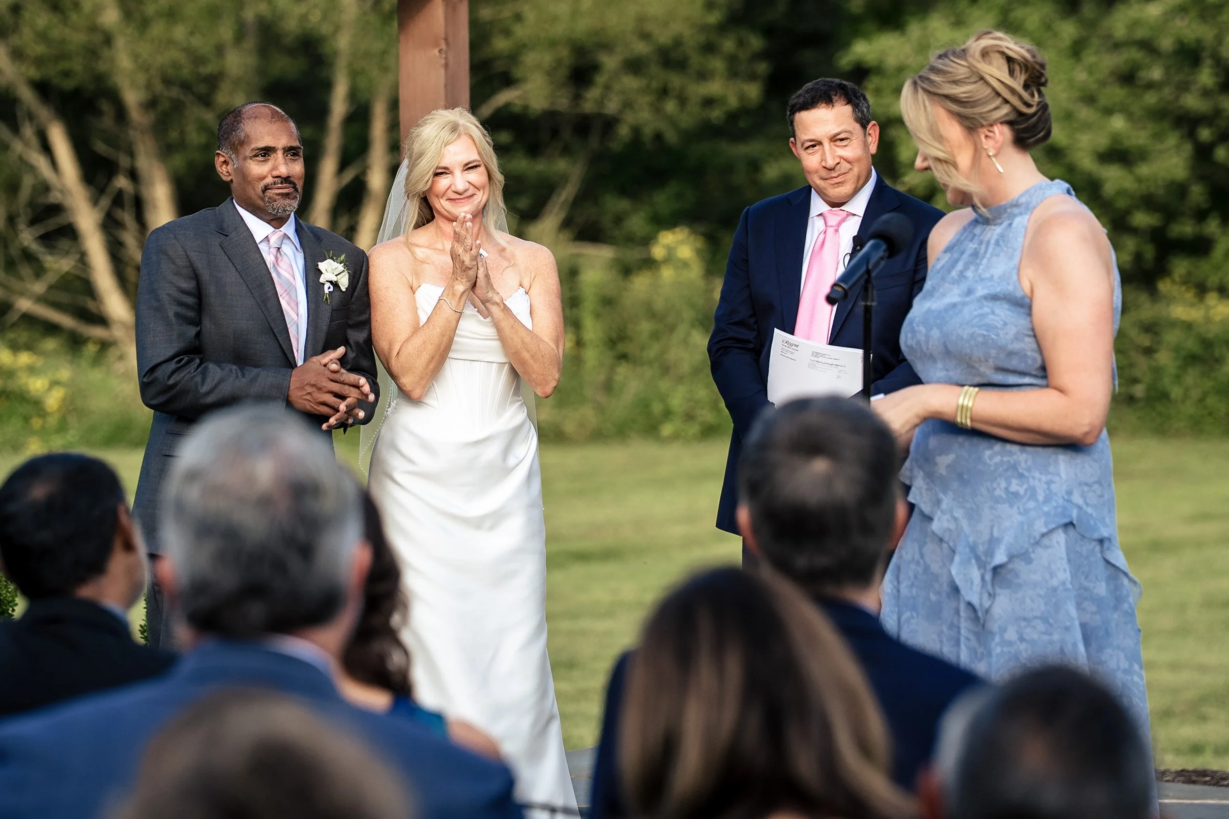 bride and groom watching friend give 7 blessings