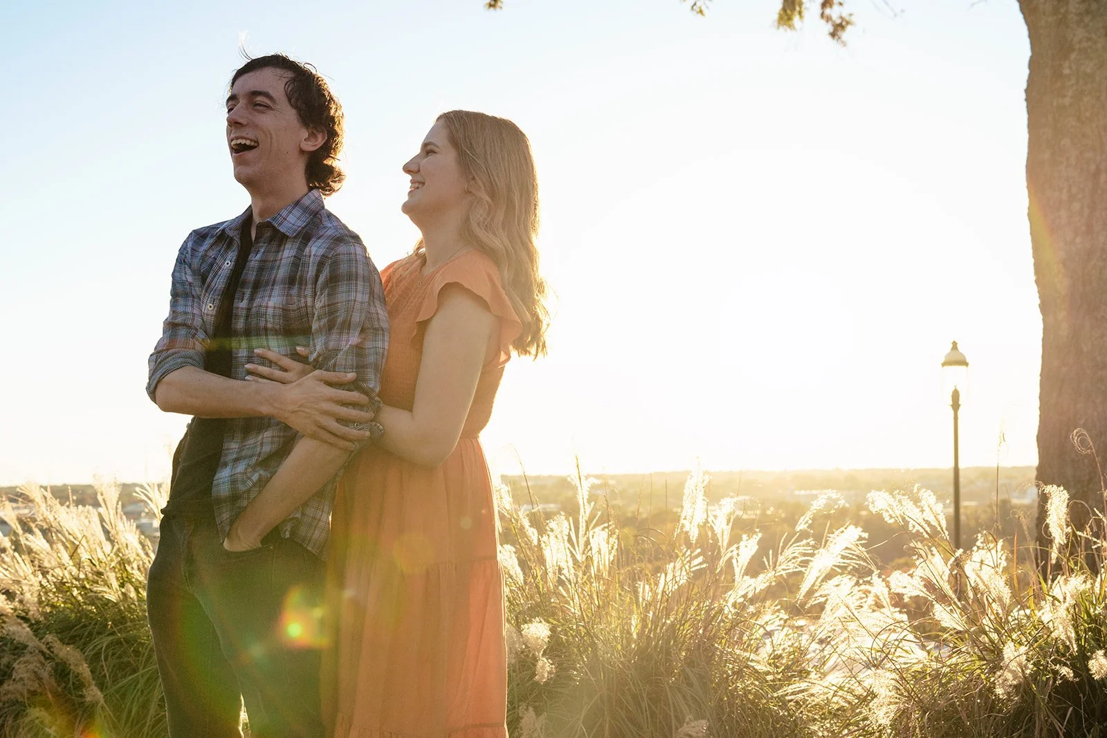 Aly and Chris laughing together in warm October light at Libby Hill Park