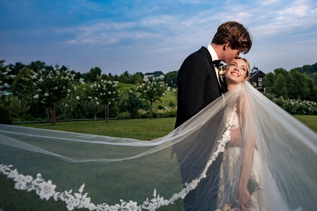 Editorial wedding portrait of Fiona and Cole beneath her veil in Northern Virginia.`