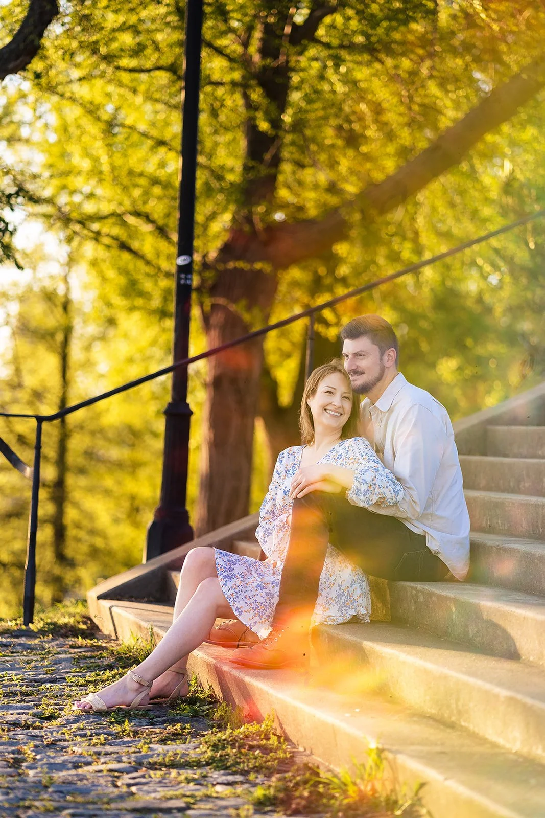 Natasha and Bryan sitting together in golden spring light at Libby Hill Park