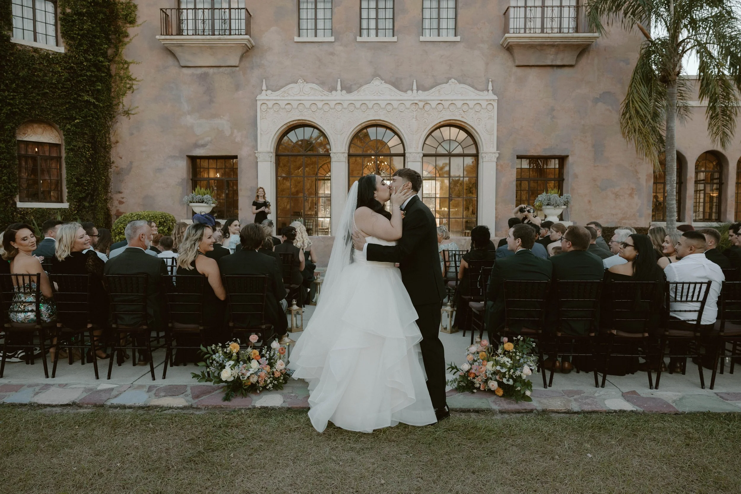bride & groom kiss at ceremony at the howey mansion in Florida