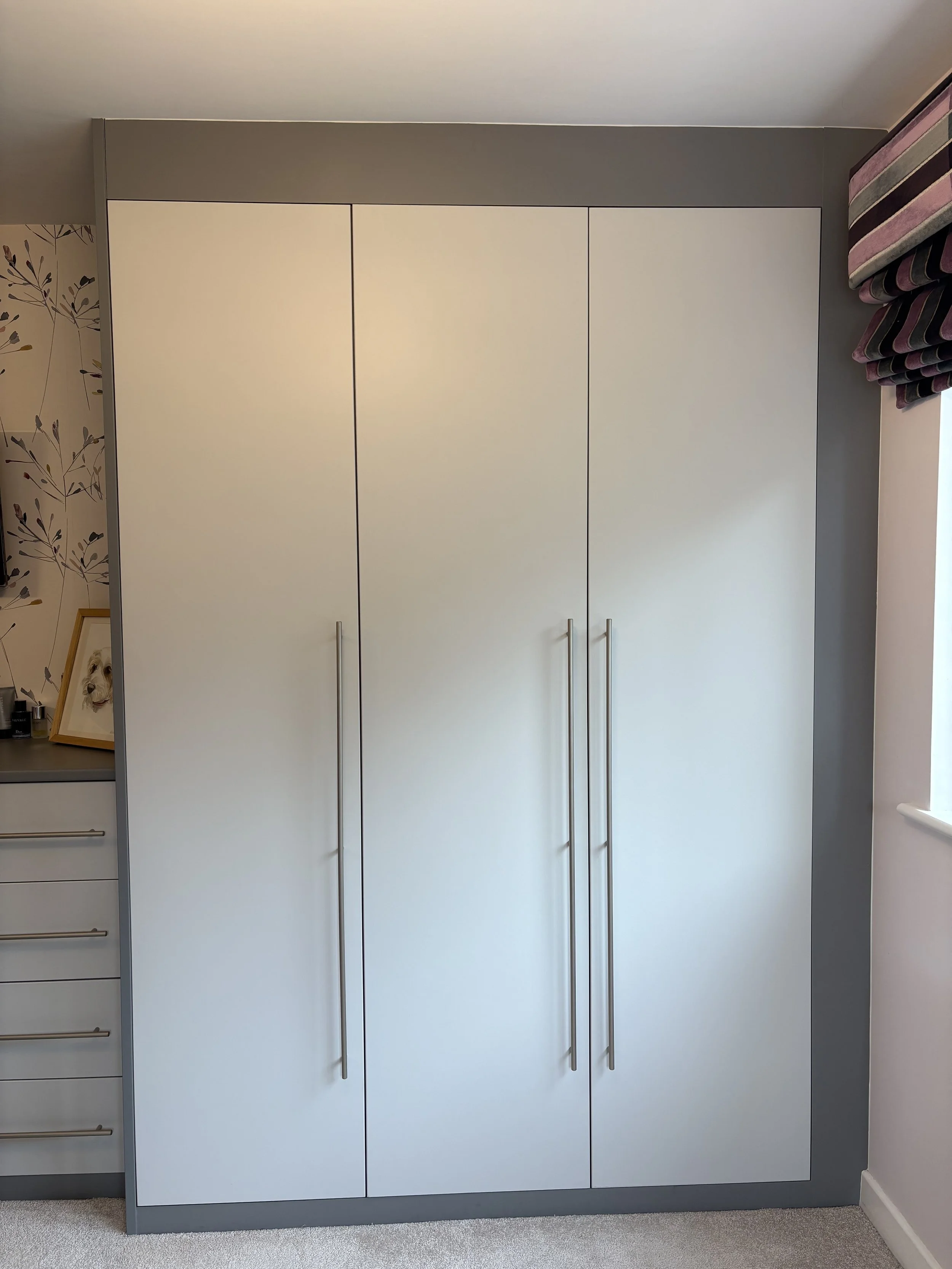 Before: primary bedroom showing dark grey wardrobe wall dominating the space before LuLa redesign