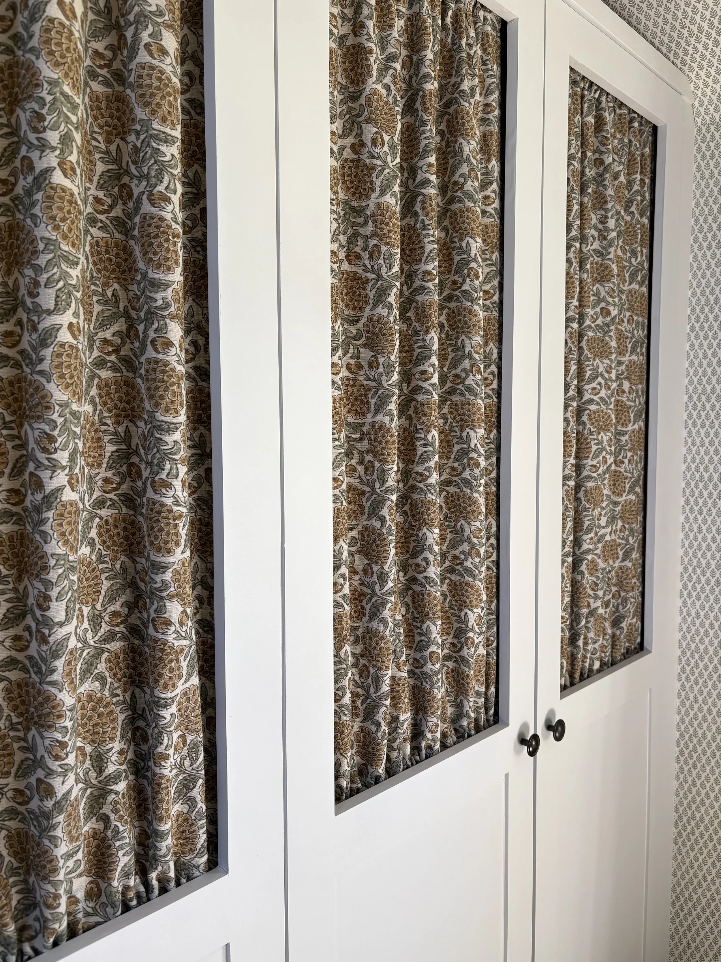 Bespoke wardrobe detail with fabric doors in a cottage-style bedroom, Leicestershire