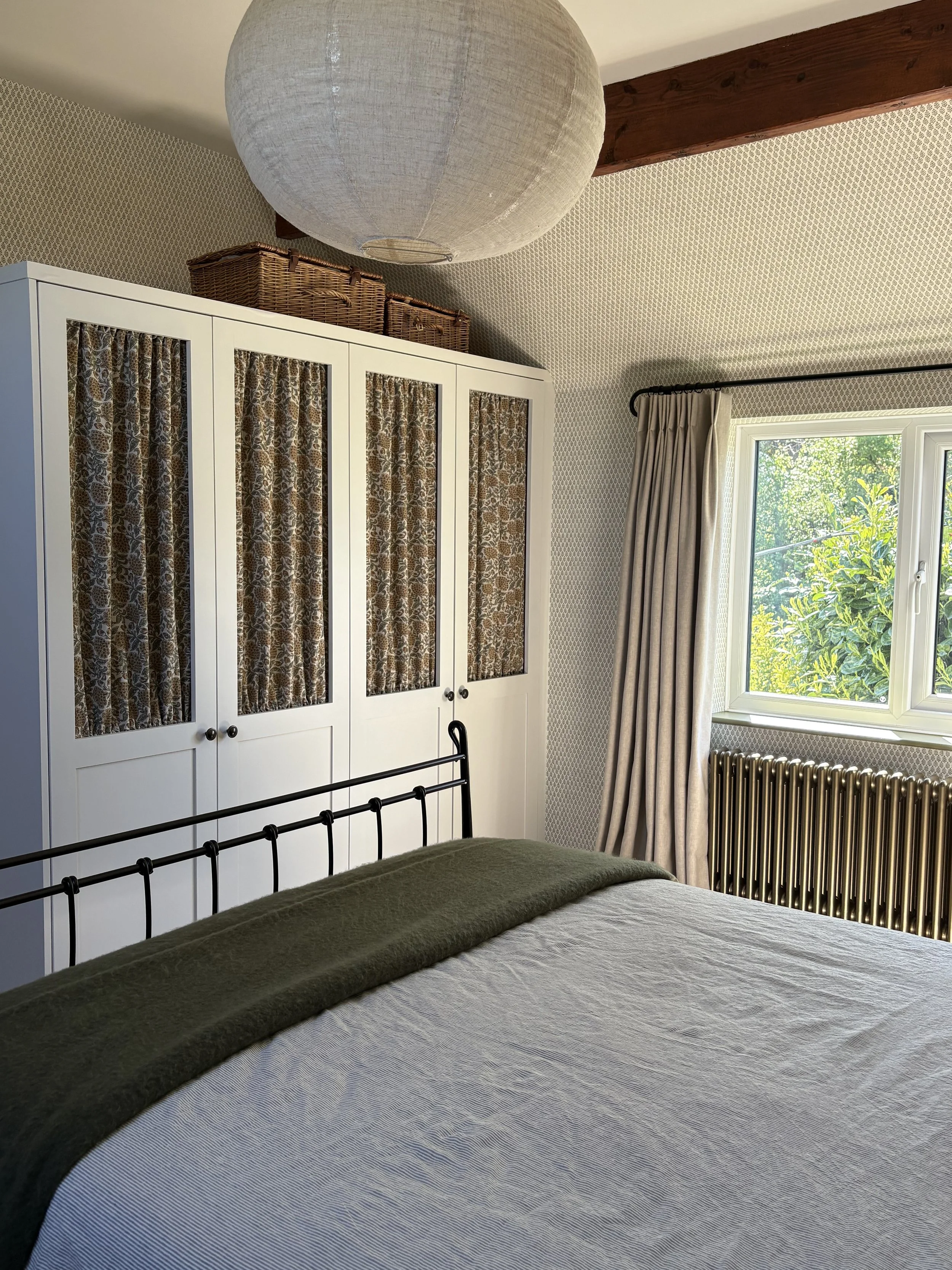 Full room view of a primary bedroom in a Leicestershire country cottage by LuLa Interior Design