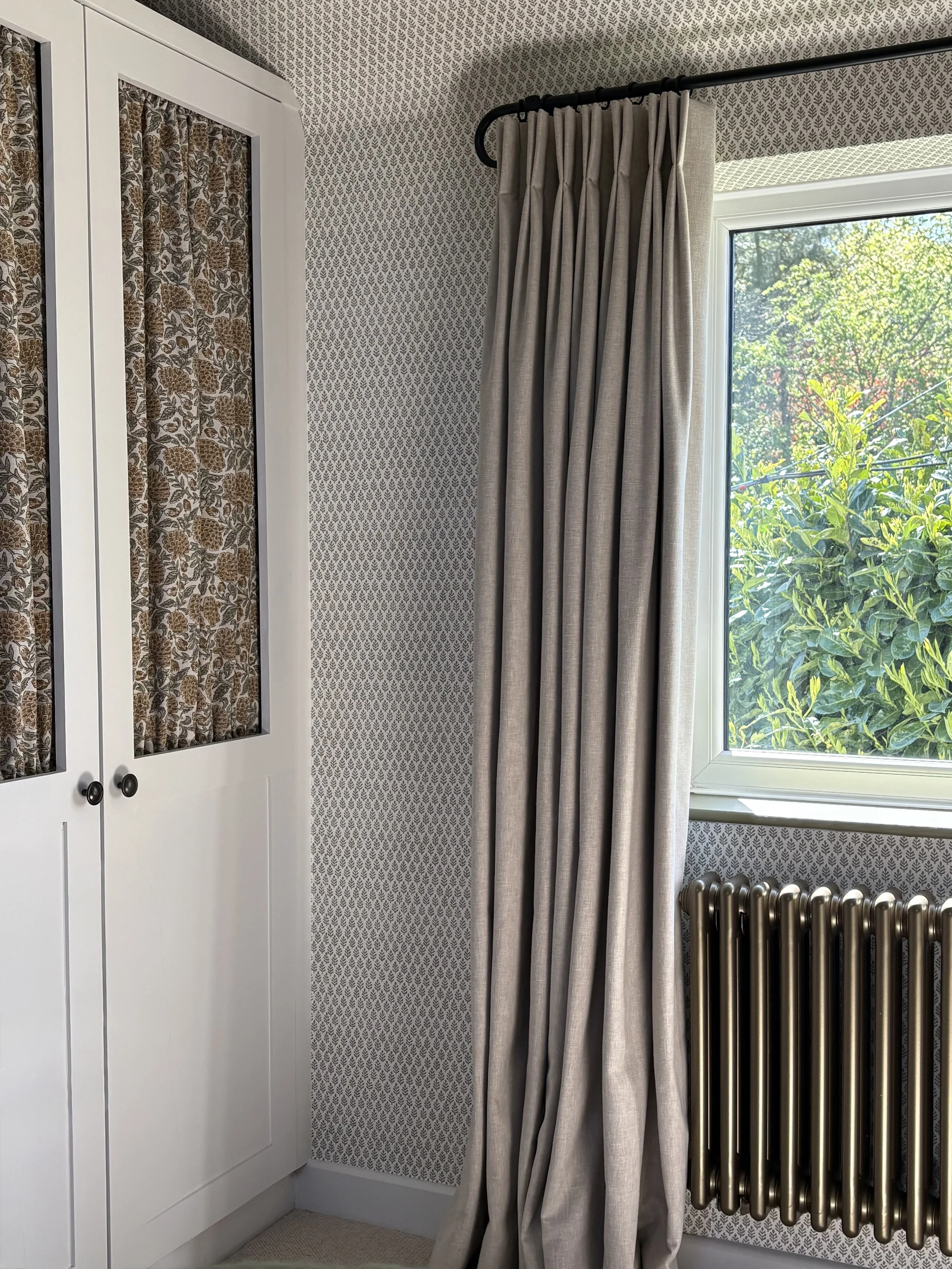 Bespoke wardrobes with fabric insert doors in a country cottage bedroom, Leicestershire