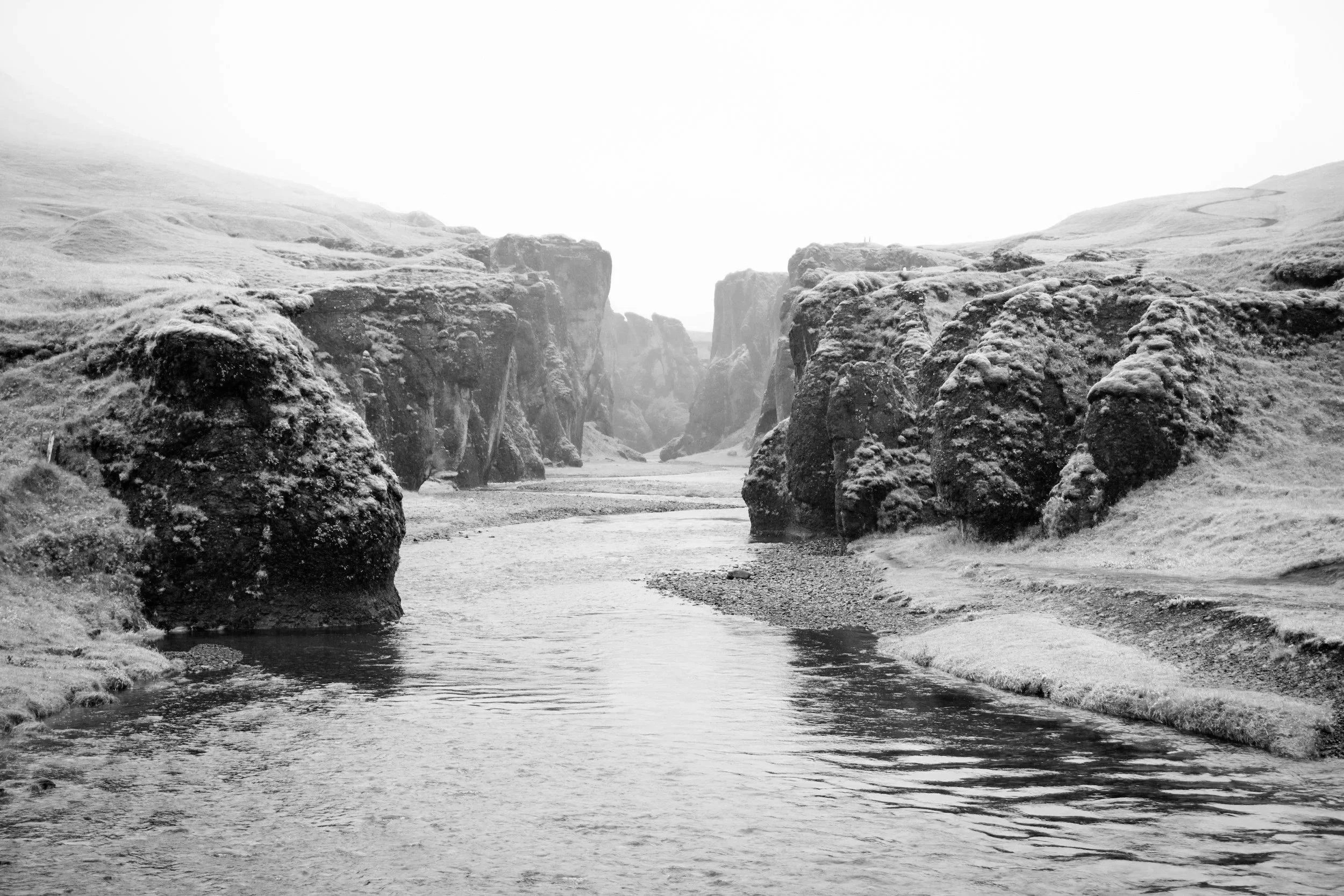 Image of gentle river running smoothly through canyon.