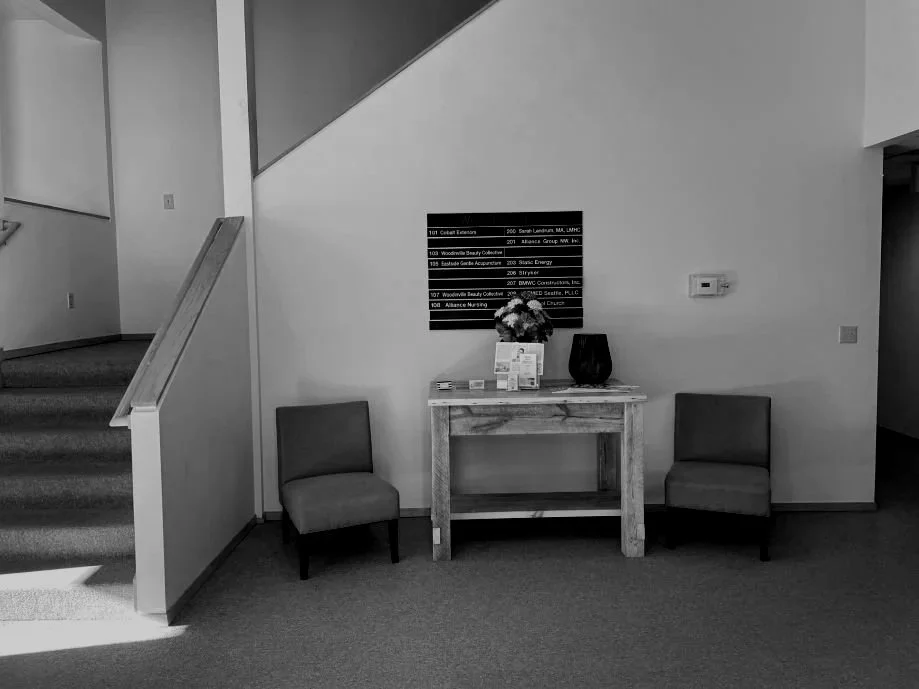 A peaceful and private waiting area at Dr. Cristina Louk's office, featuring soft lighting and comfortable seating to support nervous system regulation.