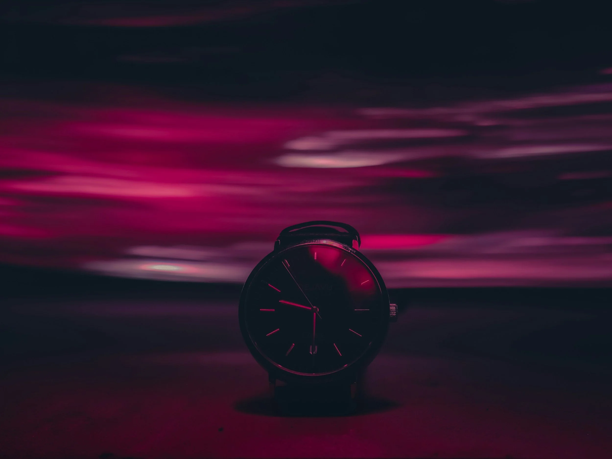 A wristwatch photographed with motion blur and streaked light, suggesting time distortion and executive functioning challenges during chronic stress.
