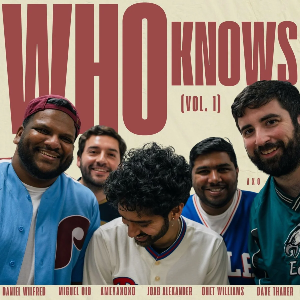 Group of five men smiling and looking down, standing in front of a beige background with large red text that reads 'WHO KNOWS [VOL. 1]'. Names listed at the bottom: Daniel Wilfred, Miguel Cid, Ameyakoxo, Joab Alexander, Chet Williams, Dave Thaker.