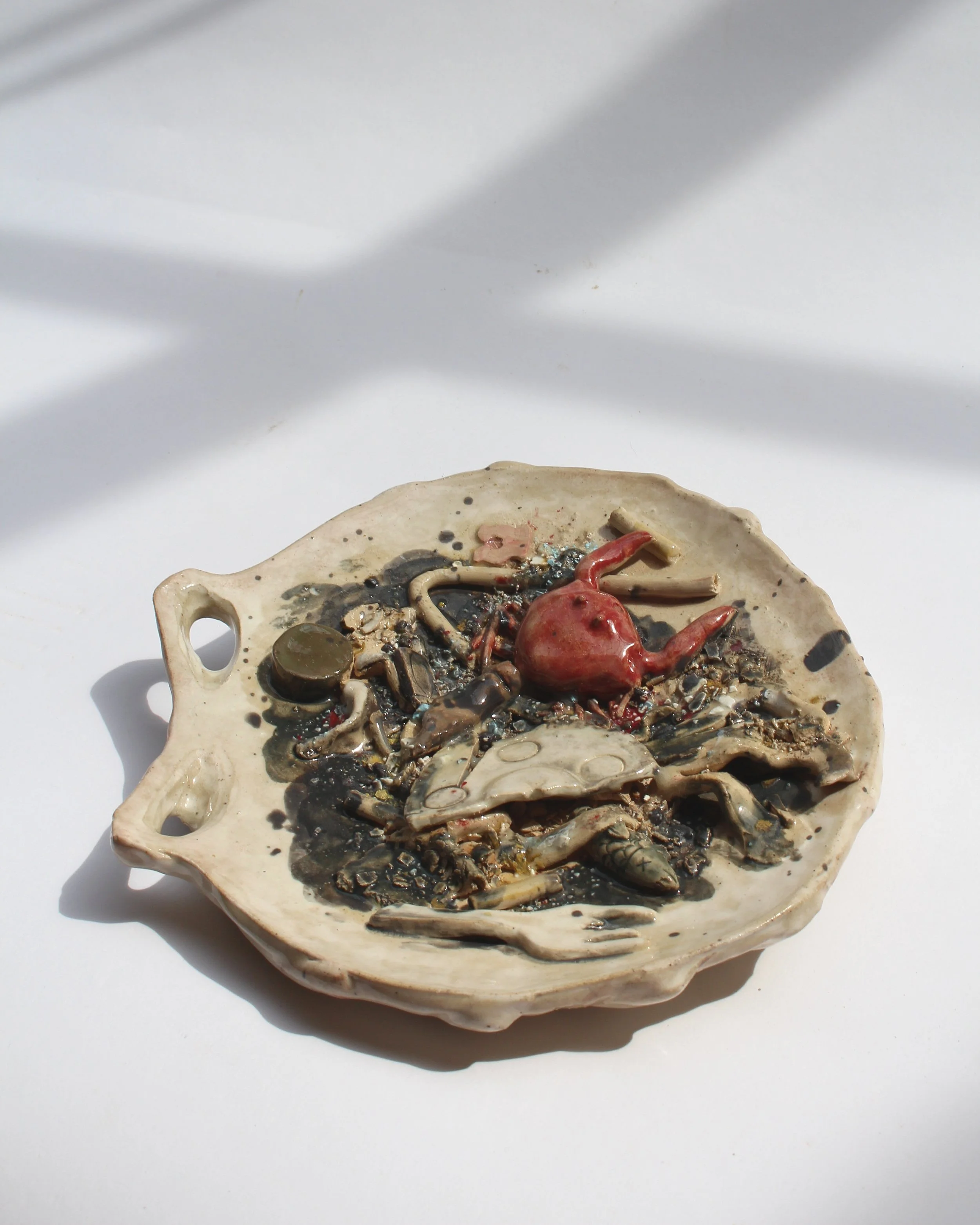 "Tidal Remains" 2025, 10 x 9 x 2, stoneware, slip, underglaze, studio waste