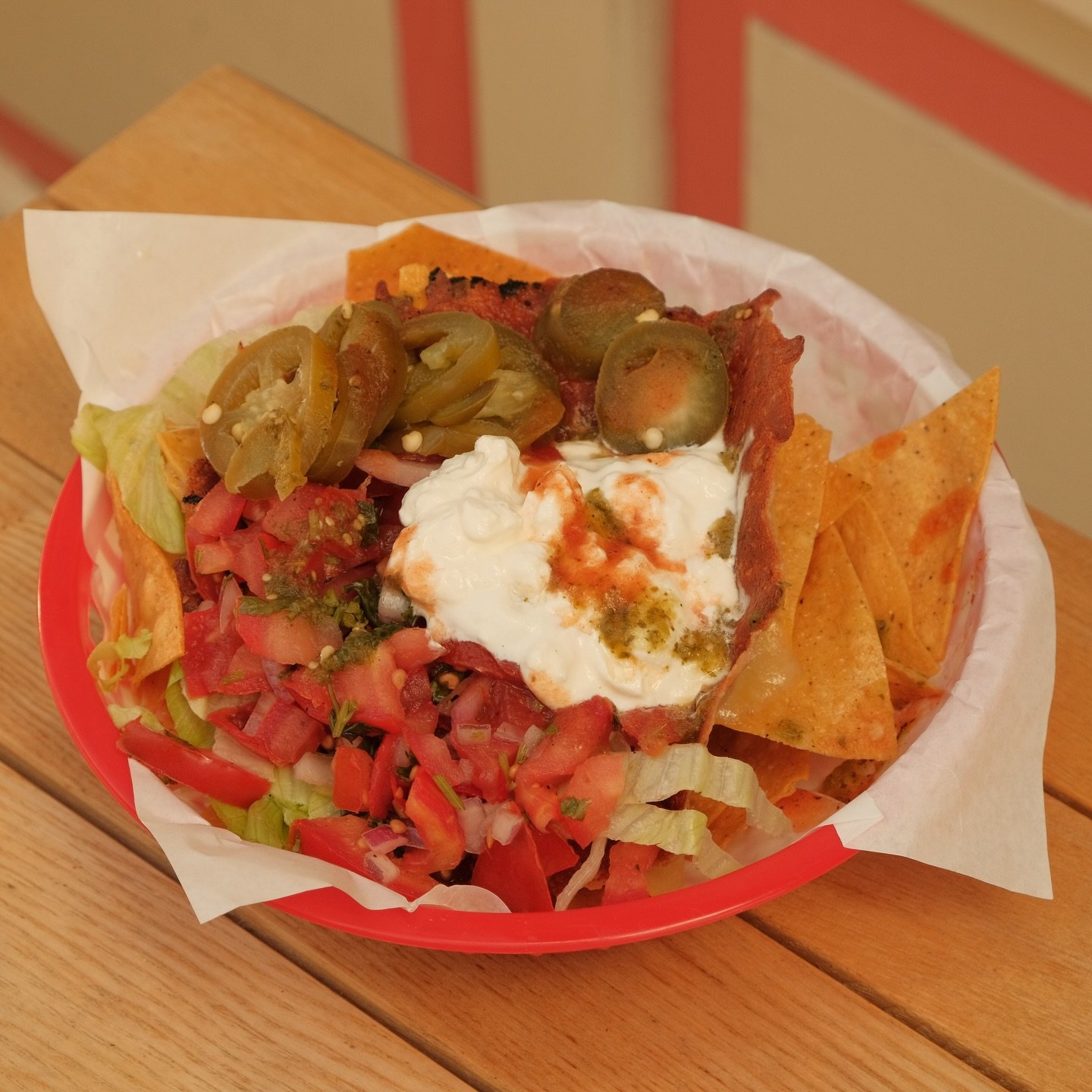 🔥 Loaded Nacho Goodness! 🔥
Check out this colorful plate stacked high with crispy tortilla chips, fresh lettuce, chunky pico de gallo, zesty jalape&ntilde;os, and a generous dollop of sour cream. Topped with salsa and all the right spices&mdash;thi