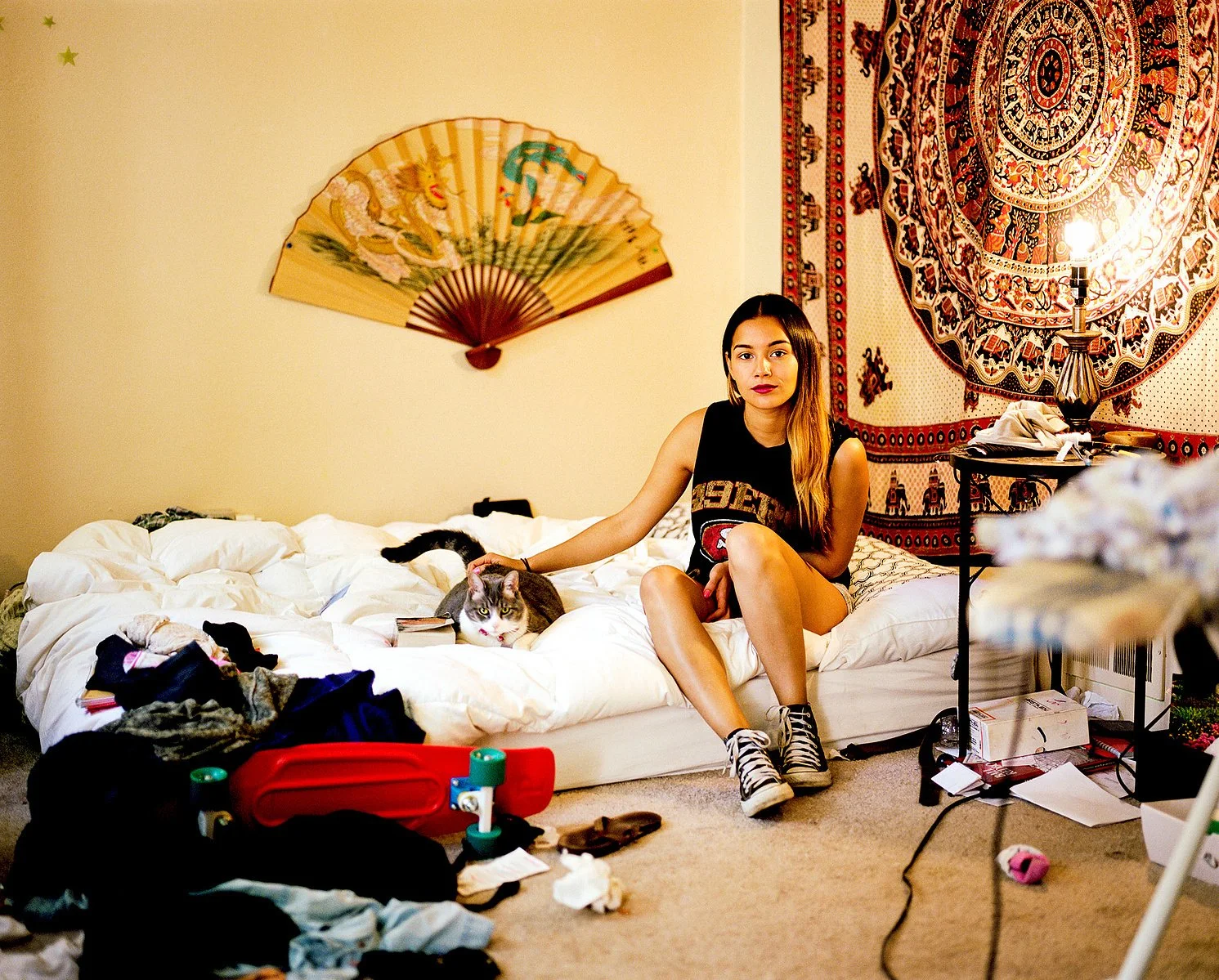  Mandy Linares in her room with her cat. Photographed when she was 22 years old. Mandy is the daughter of Nicaraguan and Salvadoran immigrant parents who moved to the states when they were teenagers. 