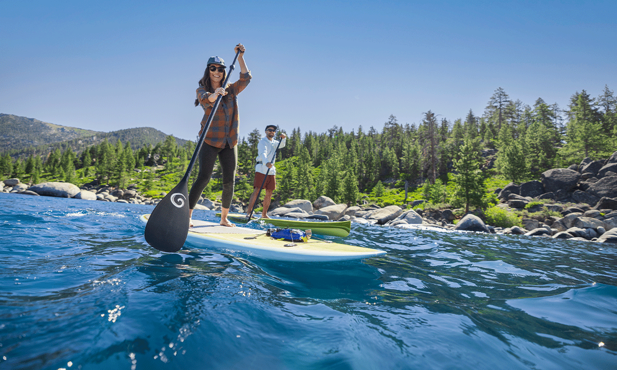 Couple paddle boarding on Lake Tahoe in Summer