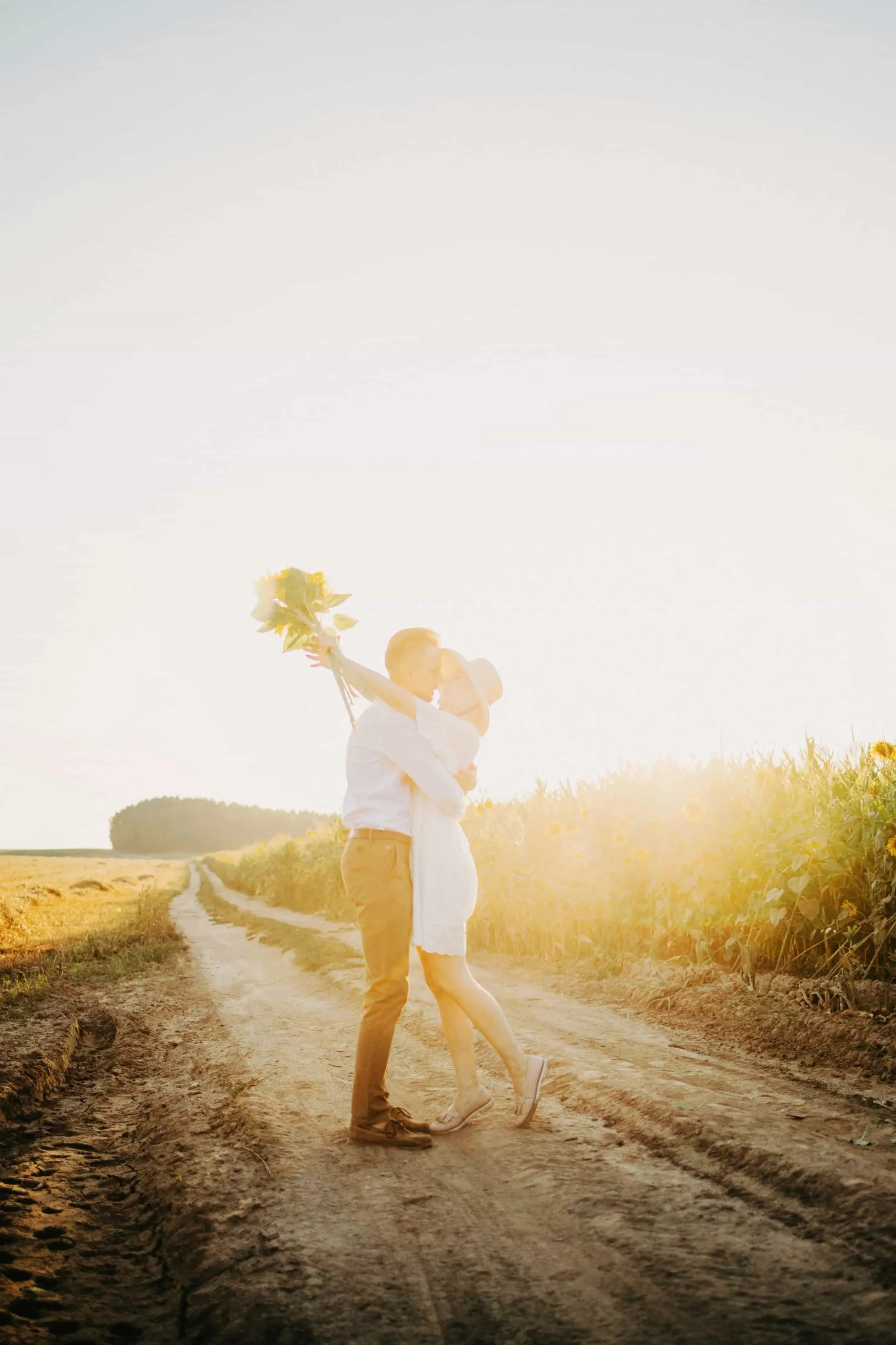 Couple embracing in a sunlit field, symbolizing secure attachment, emotional healing, and Christian relationship counseling for women and young adults in Texas.