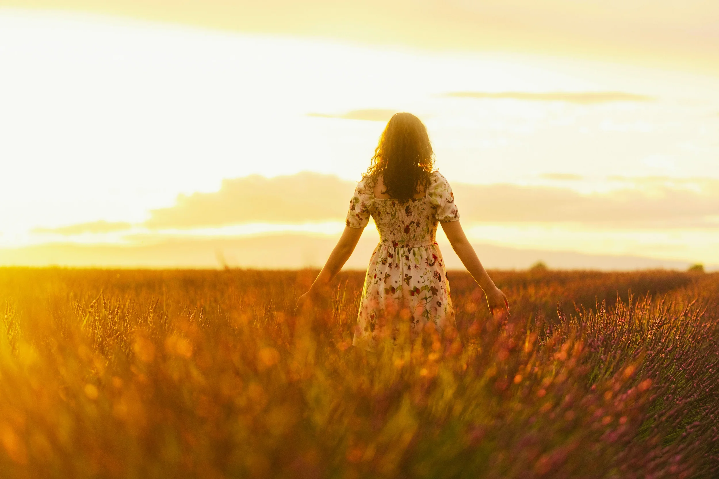 Christian teen girl walking through a golden field at sunset, representing hope, emotional healing, and faith-based anxiety and depression counseling for teens in Texas.