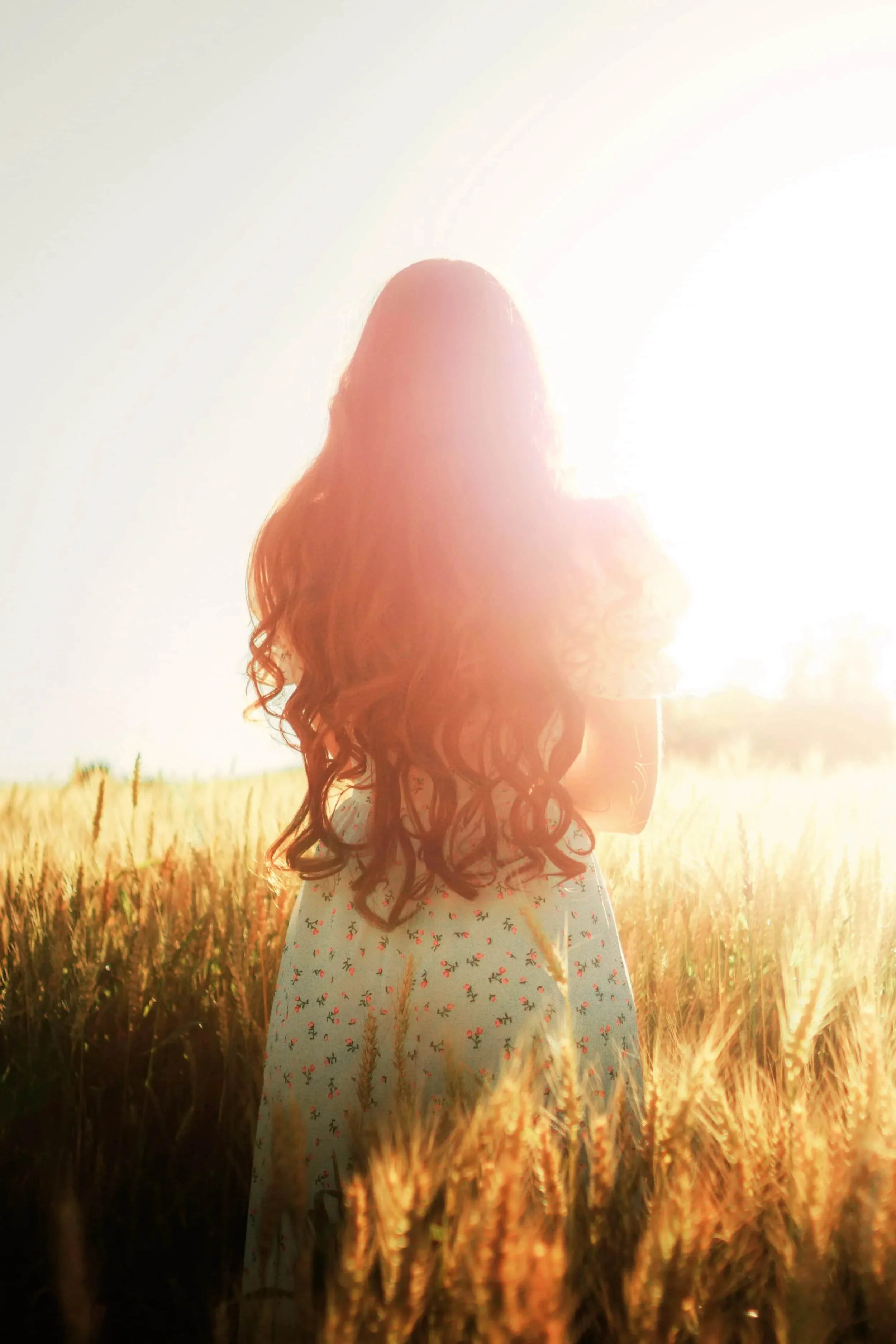 Young woman standing in a sunlit field, symbolizing relief from anxiety, emotional clarity, and hope during Christian counseling.