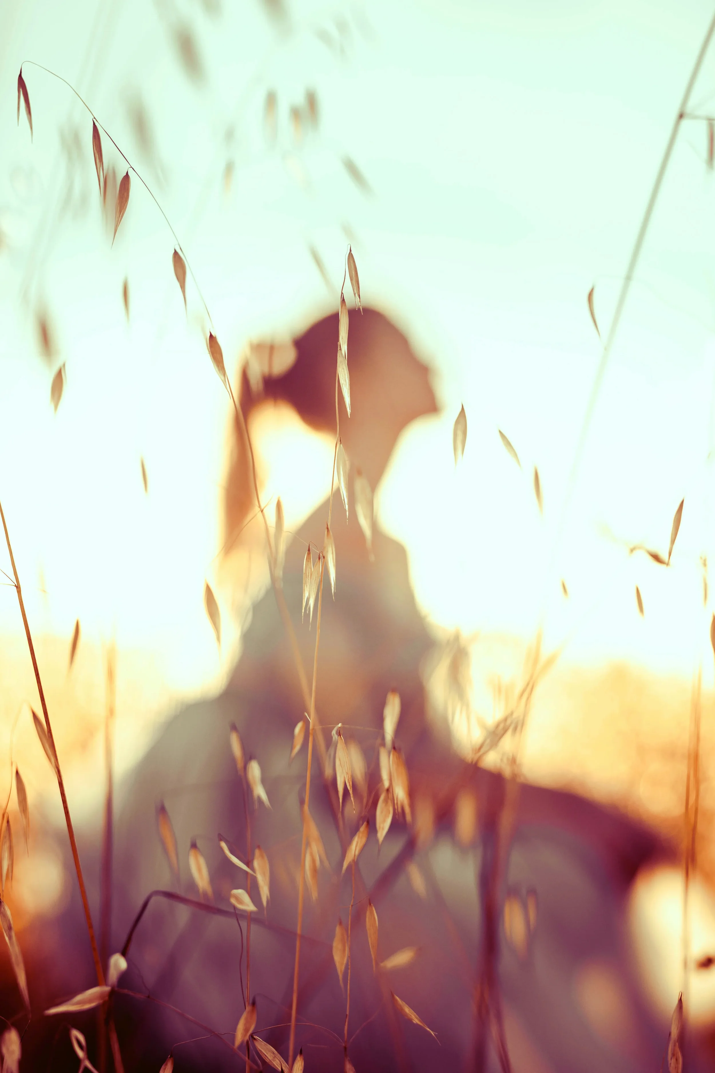 Soft sunlit silhouette of a woman in a quiet field, symbolizing peace, emotional healing, and Christian counseling for anxiety and depression in Texas.