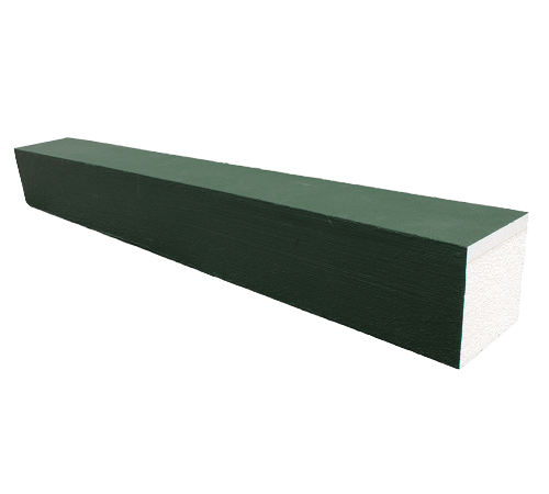 A rectangular foam wedge with a green top and white sides.