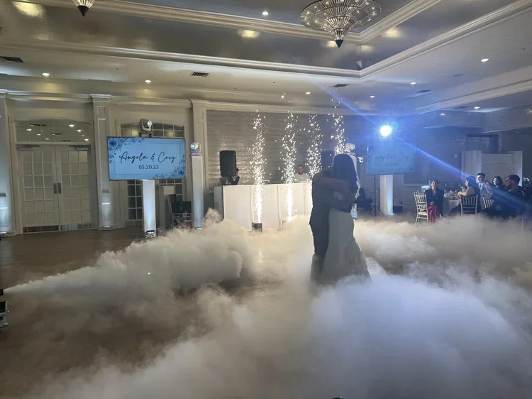 Enchanting 'Dancing on the Clouds' effect, creating a magical atmosphere with low-lying fog during a couple's first dance