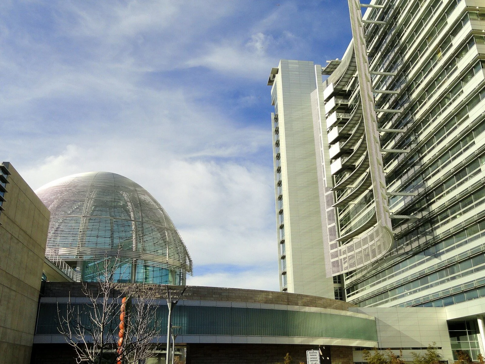 The open plaza and modern facade of San José City Hall, with its glass rotunda at one end.