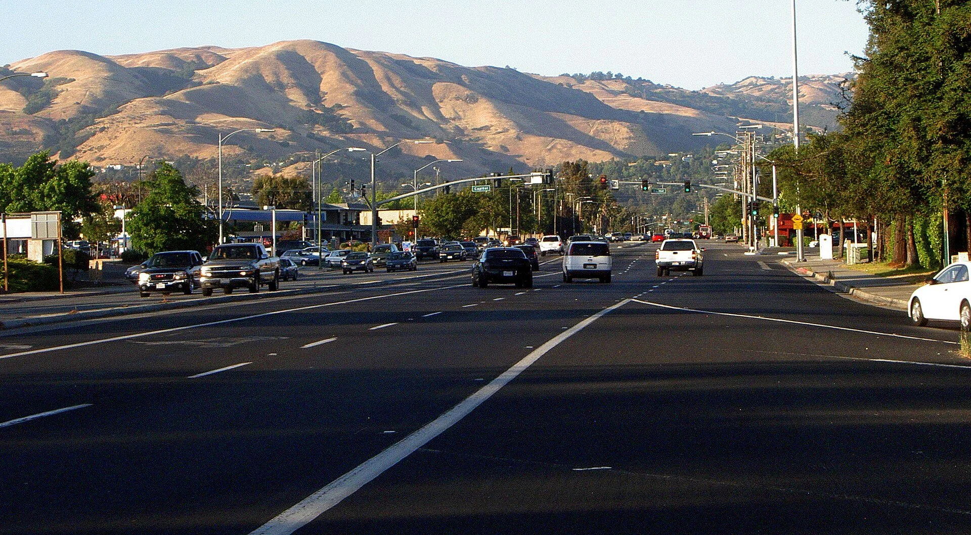 Golden grass-covered foothills east of San José under a blue sky in early summer.