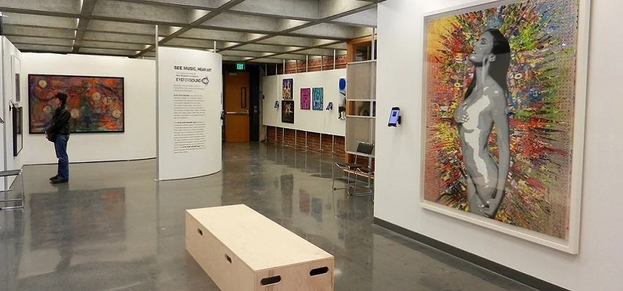 Interior of a museum gallery at New Museum Los Gatos with exhibits on the walls and floor.
