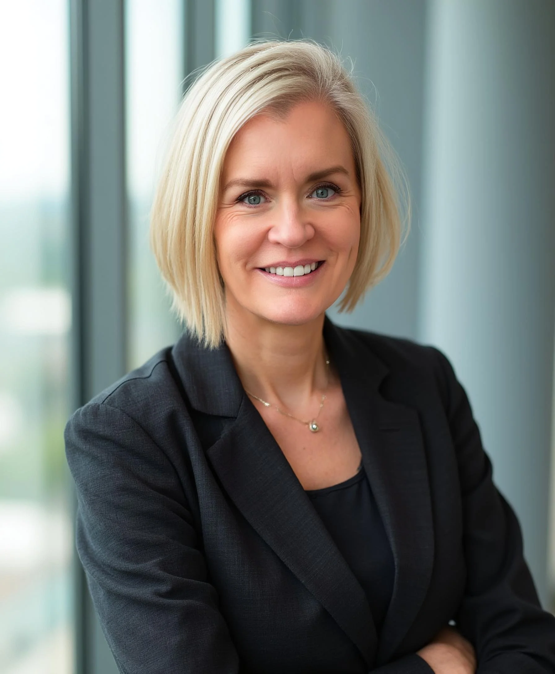 Jen Emmons standing in the office by window