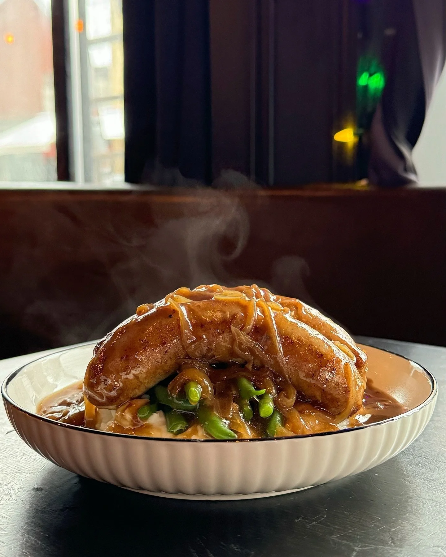 Not the #erastour you wanted but we&rsquo;ve got bangers of our own. Cumberland sausage on mash with green beans, onion, and gravy. Back on the menu @ MOK. 🤩🎫