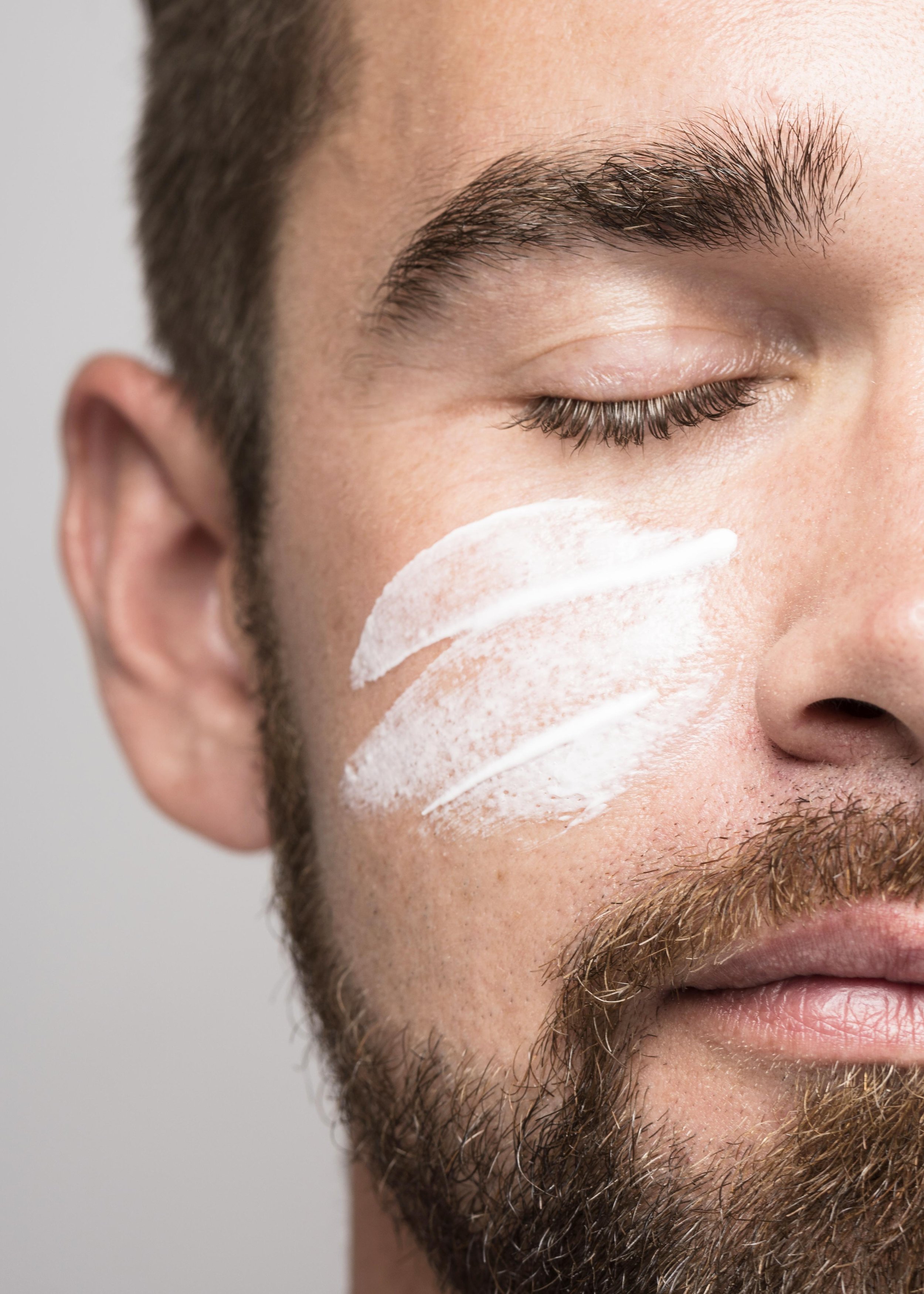 portrait-handsome-man-using-face-cream-close-up.jpg