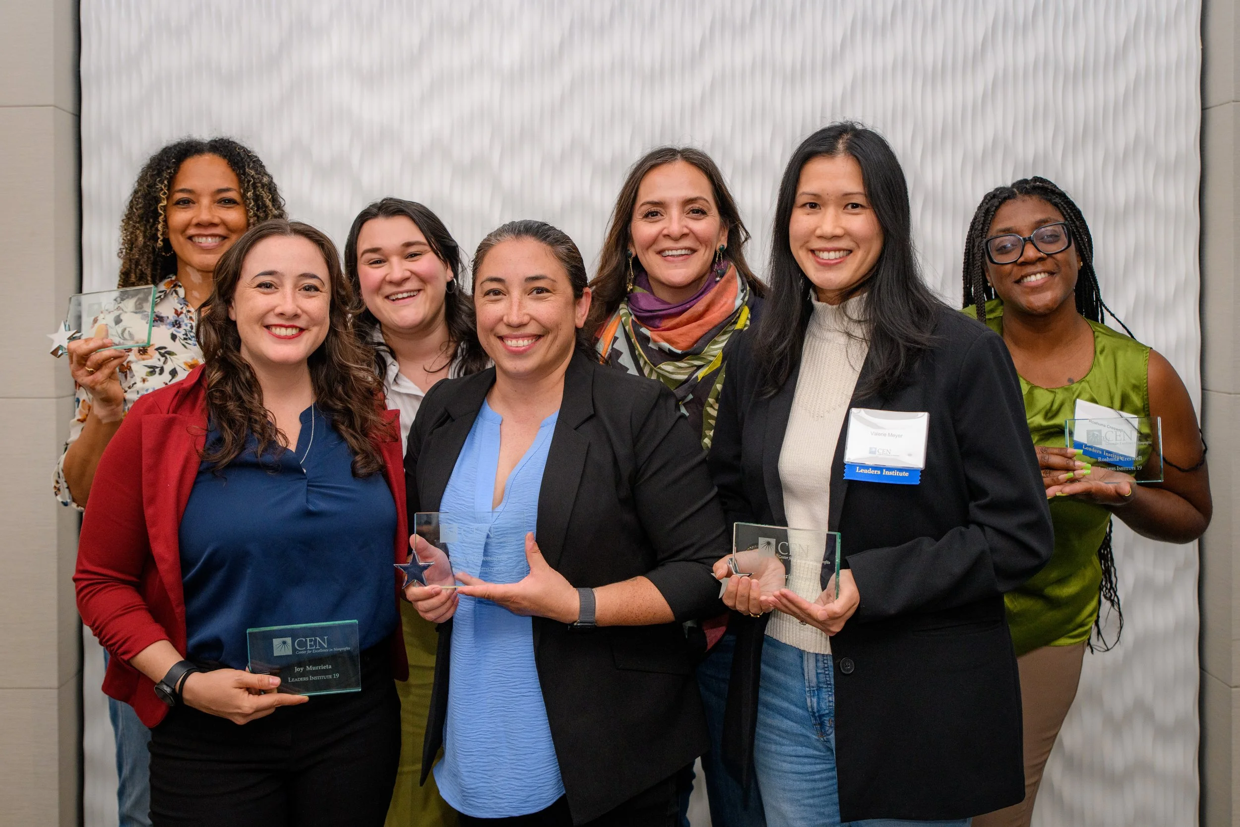 Image of CEN's 19th Cohort of Leaders Instititute smiling at the camera holding thier awards
